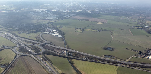 This image: aerial photo looking over the M42 J9 roundabout, the Thrive site, and 
						with the employment sites at Minworth and Castle Vale in the background.
						The map: the map shows the Thrive site boundary in the context of Peddimore, Langley SUE,
						and other key strategic sites, with the administrative boundary of Birmingham in purple.